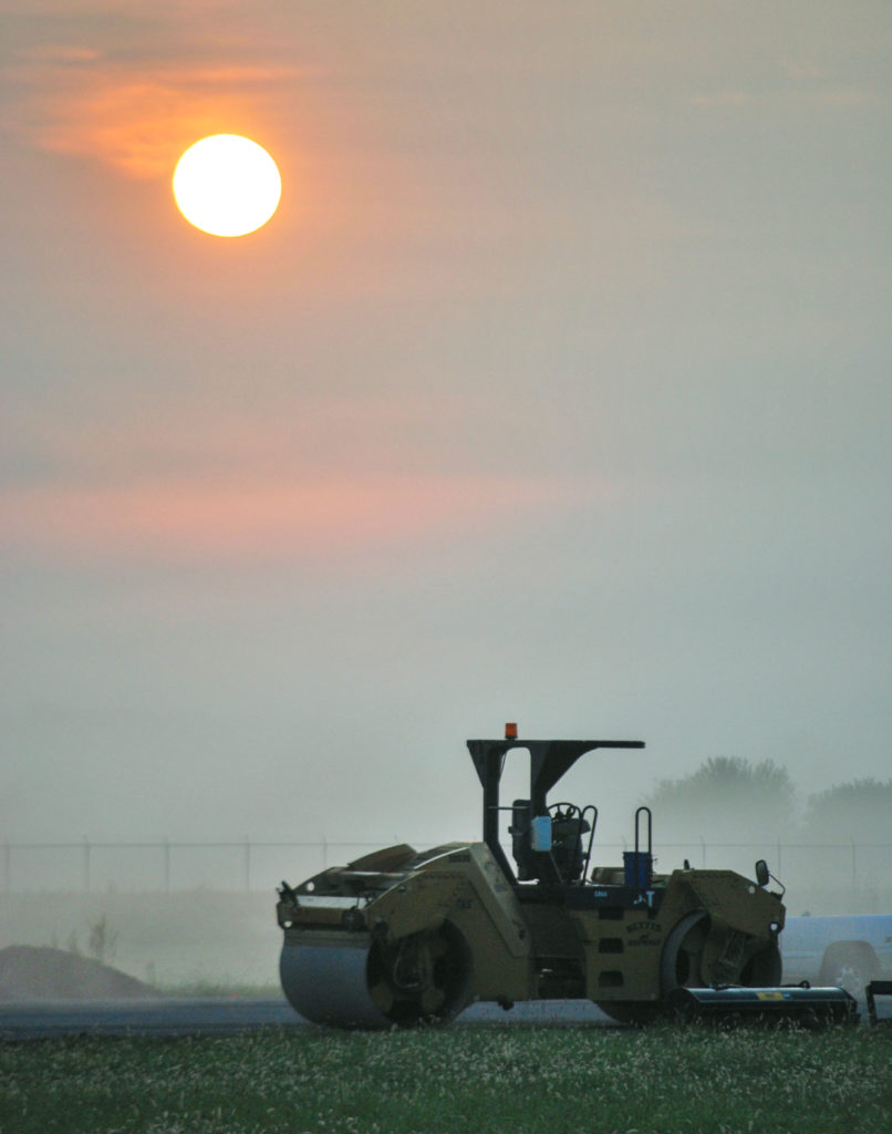 Sunrise over asphalt roller